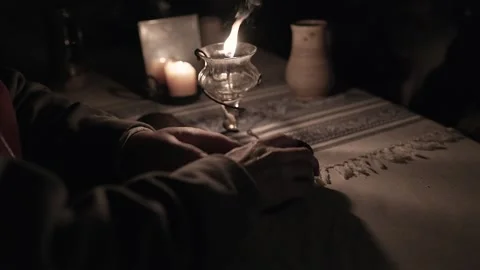 15th Century man opens a pack of playing cards by an oil lamp (B) Stock Footage 320541392