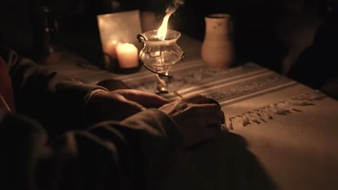 15th Century man opens a pack of playing cards by an oil lamp (A) Stock Footage 320541579
