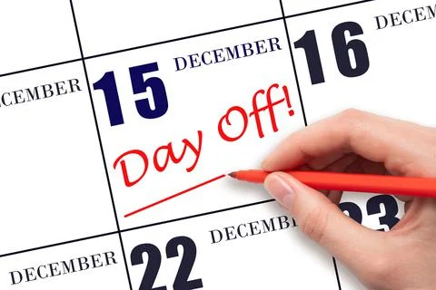 15th day of December. Hand writing text DAY OFF and drawing a line on calenda Stock Photos