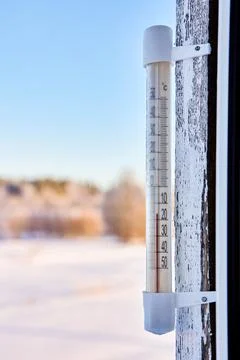 16 degrees below zero Celsius on an outdoor thermometer mounted on wooden w.. Stock Photos