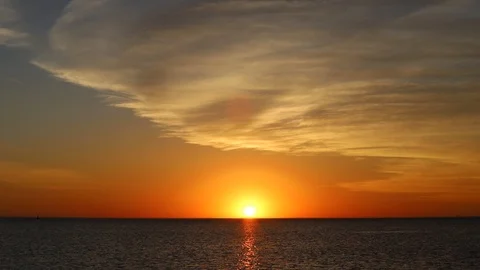 16 second clip of a sunrise with clouds over a lake horizon I Stock Footage 111733458