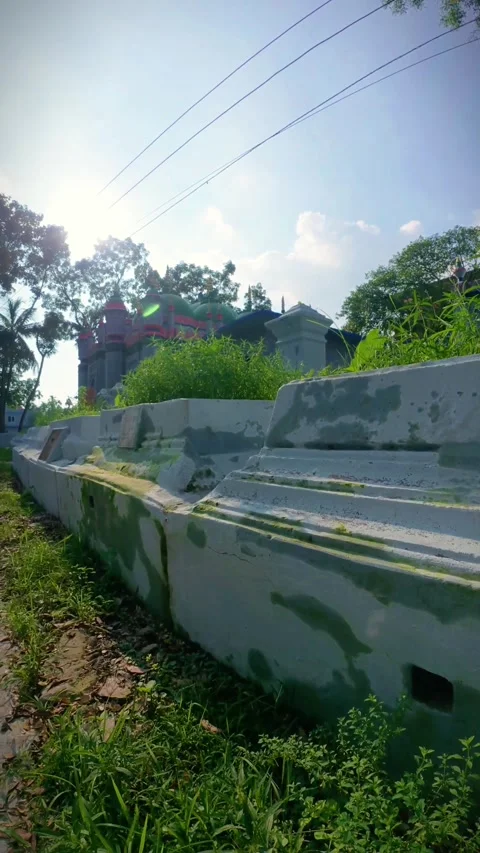 16 Tilt Up of Mosque with Evening Sun Behind Trees in Laksam, Bangladesh Stock Footage 313651372