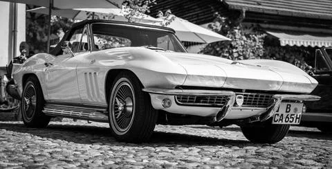 DIEDERSDORF,  GERMANY  -  AUGUST  21,  2021:  The  sports  car  Chevrolet  Corvette  Sting  Ray  Convertible  (C2),  1965.  Black  and  white.  The  exhibition  of  "US  Car  Classics". xkwx exterior,  vintage,  2-door,  america,  american,  ancient,  antique,  auto,  automobile,  automotive,  black,  c2,  car,  chevrolet,  classic,  convertible,  corvette,  design,  diedersdorf,  exhibition,  general  motors,  germany,  gm,  machine,  model,  muscle  car,  nostalgia,  old,  oldtimer,  retro,  second  generation,  sports  car,  sting  ray,  style,  transport,  transportation,  us,  usa,  vehicle,  white