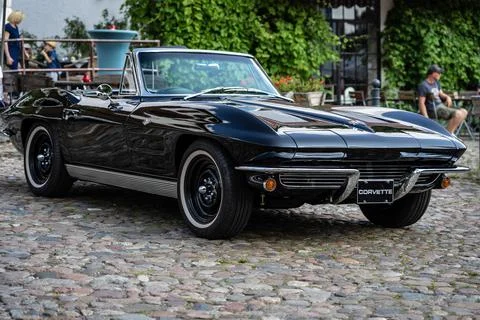 DIEDERSDORF,  GERMANY  -  AUGUST  21,  2021:  The  sports  car  Chevrolet  Corvette  Sting  Ray  Convertible  (C2),  1964.  The  exhibition  of  "US  Car  Classics". xkwx america,  american,  ancient,  antique,  auto,  automobile,  automotive,  car,  classic,  design,  diedersdorf,  exhibition,  germany,  machine,  model,  nostalgia,  old,  oldtimer,  retro,  style,  transport,  transportation,  us,  usa,  vehicle,  vintage,  exterior,  2-door,  sports  car,  Chevrolet,  Corvette,  Sting  Ray,  Convertible,  C2,  second  generation,  GM,  General  Motors,  black,  muscle  car