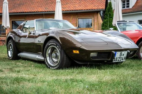 DIEDERSDORF,  GERMANY  -  AUGUST  21,  2021:  The  sports  car  Chevrolet  Corvette  Stingray  (C3),  1976.  The  exhibition  of  "US  Car  Classics". xkwx america,  american,  ancient,  antique,  auto,  automobile,  automotive,  car,  classic,  design,  diedersdorf,  exhibition,  germany,  machine,  model,  nostalgia,  old,  oldtimer,  retro,  style,  transport,  transportation,  us,  usa,  vehicle,  engine,  sports  car,  Chevrolet,  Corvette,  coupe,  2-door,  c3,  Vette,  muscle  car,  exterior,  Stingray,  vintage