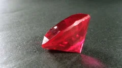 Clear transparent red ruby stone. Macro rotating filming of precious crystals.