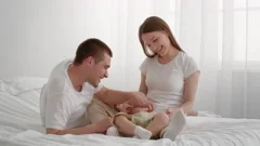 Loving Parents And Their Cute Adorable Baby Playing With Xylophone In Bedroom
