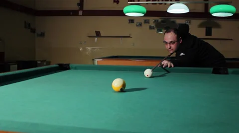 16/35 Man playing billiard. Player is taking a shot and put ball in the hole. Stock Footage 36427638