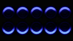 A set of modern sound speakers illuminated by rotating neon lights
