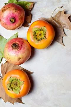 Vertical autumn composition with ripe seasonal fruits and leaves on the ...
