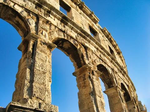 A low angle shot of the arch and vault of the Pula Arena in Croatia ...