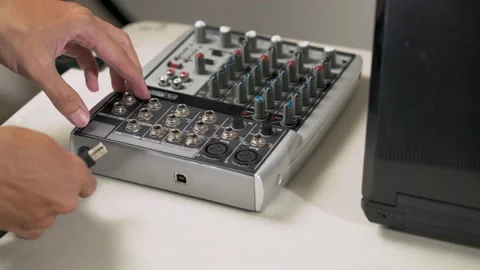 16_hand plugging a cable into the audio mixer Video stock 156025177