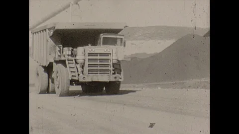 16mm dump trucks on surface mining site Stock Footage 129842220