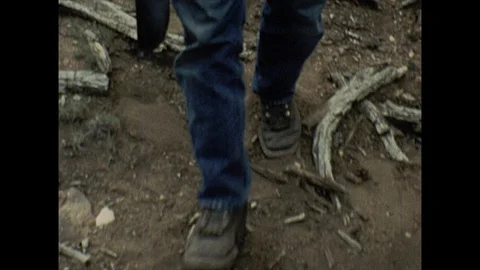 16mm man walks through forest toward camera Stock Footage 129862880