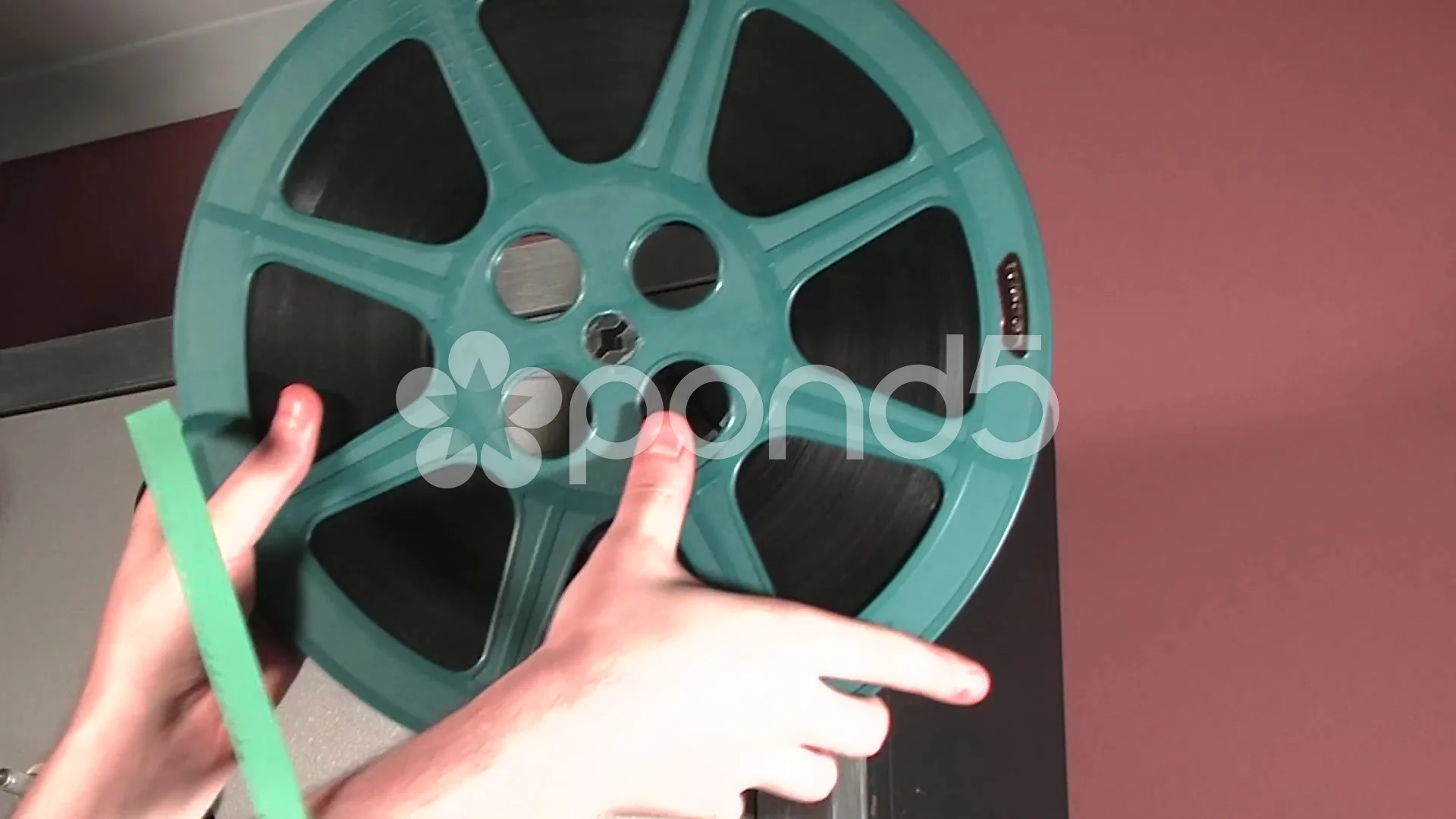 16MM MOVIE FILM REEL BEING PLACED ON PRO, Stock Video