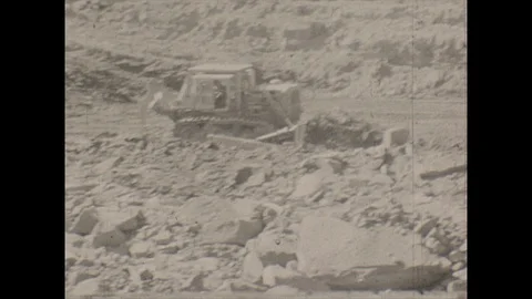 16mm pan bulldozers on surface mining site Stock Footage 129865399