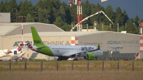 17-August 2025, Brnik, Slovenia An Air Baltic plane is taxiing Stock Footage 315362853