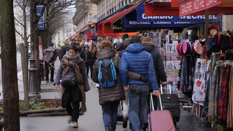 17 Rainy gray winter day Paris tourists walking along souvenirs shops layout Stock Footage 100814236