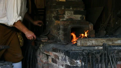 1700s Blacksmith stoking fire Stock Footage 168086826