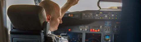 Focused professional pilot sitting in an airplane cabin, ready for takeoff. Aircraft, aircrew, occupation concept xkwx adult, adults, air, aircraft, airline, airliner, airplane, airport, attractive, auto pilot, aviator, background, boarding, business, cabin, cockpit, commercial, crew, flight, fly, focused, guy, horizontal, job, journey, landing, man, occupation, people, person, pilot, plane, preparing, professional, ready, real, service, simulator, sitting, takeoff, tourism, transport, transportation, travel, trip, uniform, work