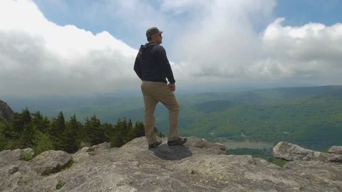 178 Man standing on top of a mountain Stock Footage 104446262
