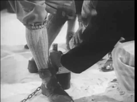 17th century reenactment of release of prisoner in shackles Stock Footage 61444896