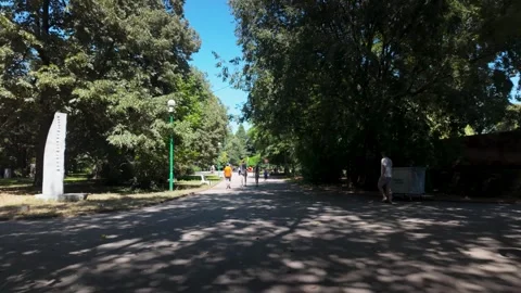 18 August 2026 Sofia, Bulgaria. People walking on a shaded park path Stock-Footage 344650413