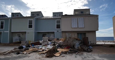18 gutted condominiums tracking left debris piles in foreground some demolished Stock Footage 98767358