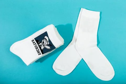 18 March 2021 a stack of white socks with Disneys heroes on blue background . Stock Photos