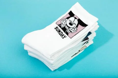 18 March 2021 a stack of white socks with Disneys heroes on blue background . Foto stock