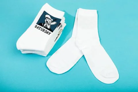 18 March 2021 a stack of white socks with Disneys heroes on blue background . Foto stock