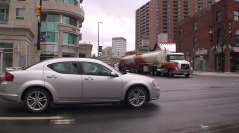 18 wheelers driving through a down town main street. #19-22 Stock Footage 35595992