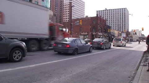 18 wheelers driving through a down town main street. Stock Footage 35630034