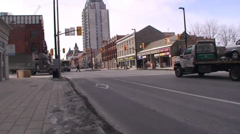 18 wheelers driving through a down town main street. #12-26 Stock Footage 35630043