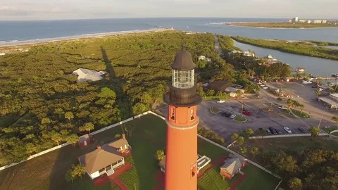 180 degree wrap around lighthouse flight revealing Florida pristine beach Stock Footage 70674265