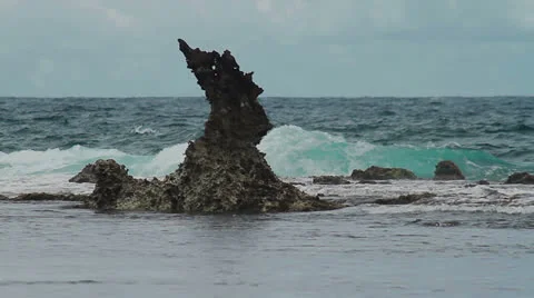 181 Ocean waves breaking on a sharp rock Stock Footage 23314812