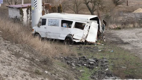 183 Broken white minibus at the side of the road, loaded with luggage, car a Stock Footage 124435170