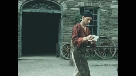 1840s: apprentice holding papers for older man while he reads them Stock Footage 170835188