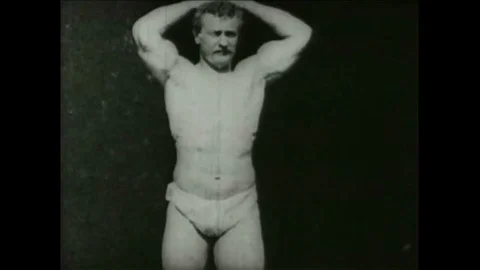 1894 - Vaudeville strongman Eugen Sandow flexing biceps muscles. Stock Footage