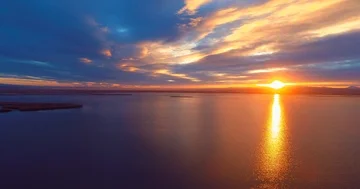 19 Flying over the lake up to dramatic sunset above the peninsula. Beautiful Stock Footage 85672778