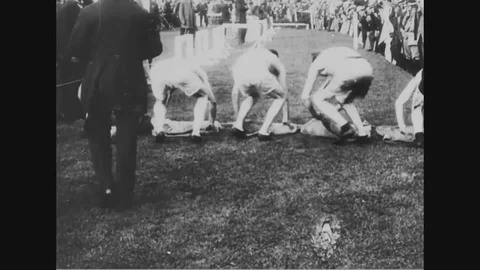 1900 - Athletes compete in a sack race and they run through an obstacle course Stock Footage