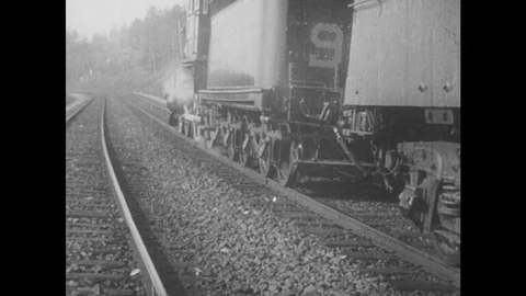 1900s: UNITED STATES: train engine leaves carriages behind. Robber forces Stock Footage 80209197