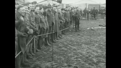 1910s: Army mechanics remove engine rotator from Sopwith Camel plane parked on a Stock Footage 215917344