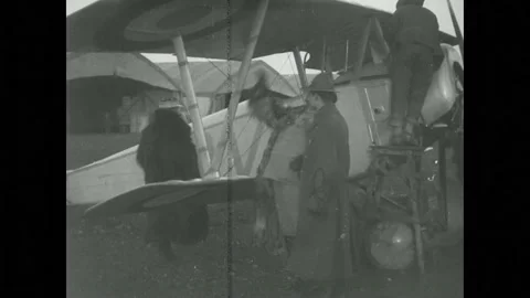 1910s: Army mechanics replace engine rotator on Sopwith Camel plane parked on a Stock Footage 215917404