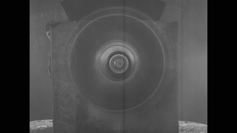 1910s: Biplane propeller and engine spin to a stop in factory. Men scavenge Stock Footage 137404965