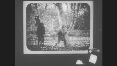 1910s: First-person-point-of-view in a movie theater. Movie is a Western of an Stock Footage