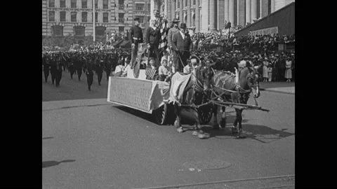 1910s: Float in parade. Marching band. Men in top hats. Floats in parade. Stock Footage 141347467