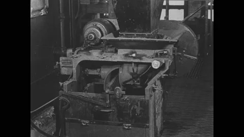 1910s: Machines inside factory. Intertitle. Man push cart full of coal in mining Stock Footage 158968376