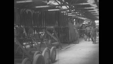 1910s: Men stack propellers and tires in biplane construction factory. Men 스톡 동영상 137404996