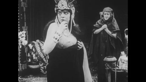 1910s: UNITED STATES: lady stares into space. Lady looks and reaches to sky Stock Footage